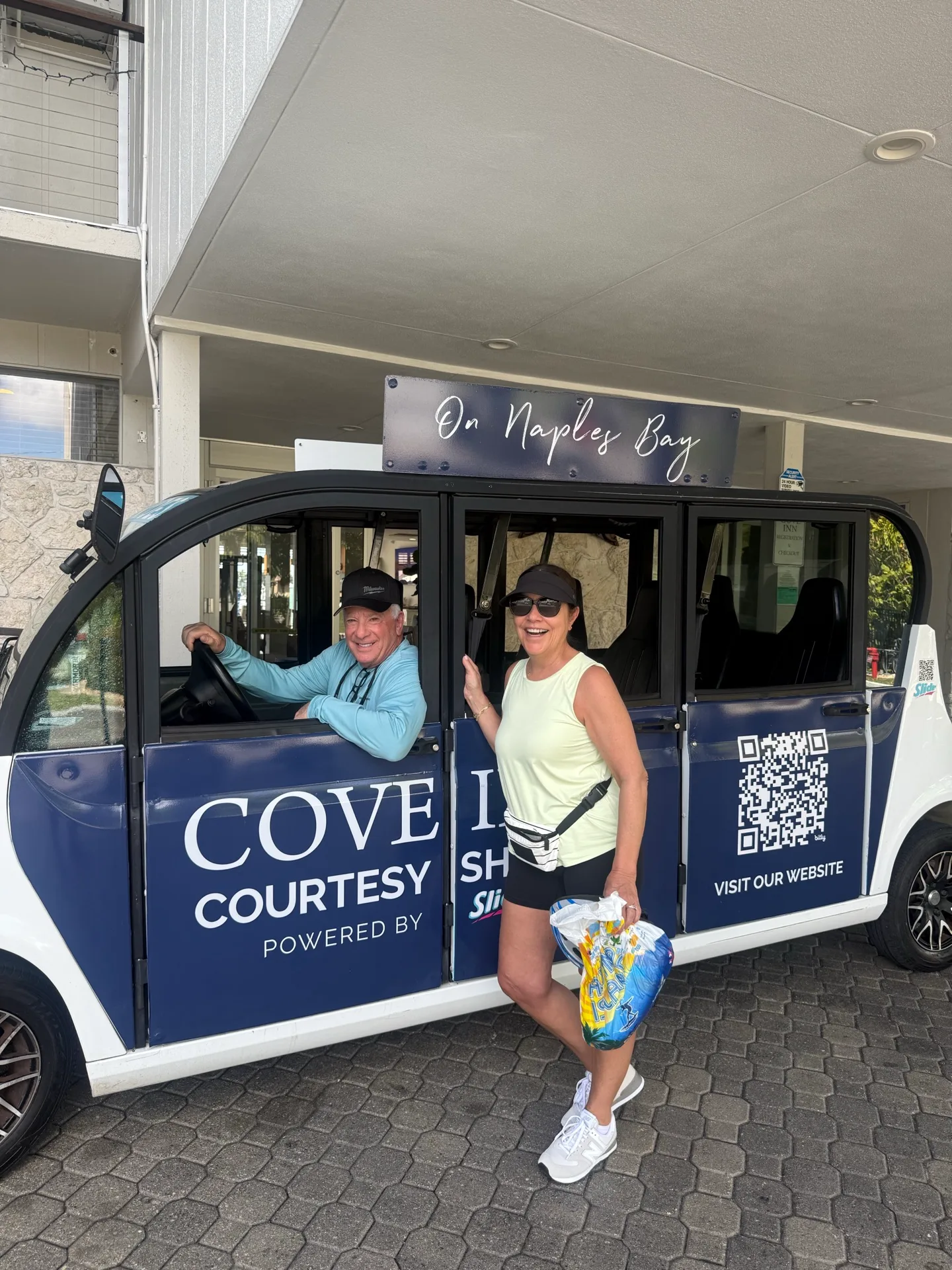 Two guests in the Cove Inn on Naples Bay courtesy shuttle outside the hotel in Naples, Florida